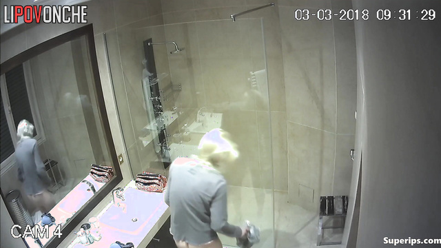 Blonde taking bath, unaware someone is quietly watching