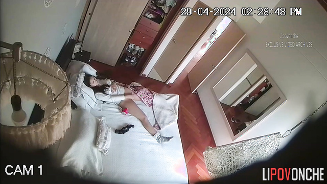 Skinny brunette masturbates with a vibrator on the bed