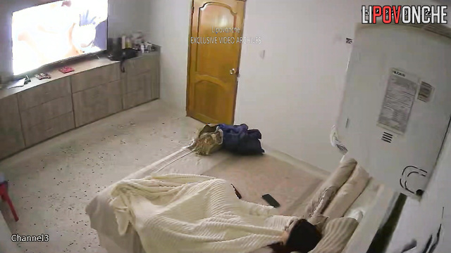 Brunette masturbating with a small sex toy under sheets