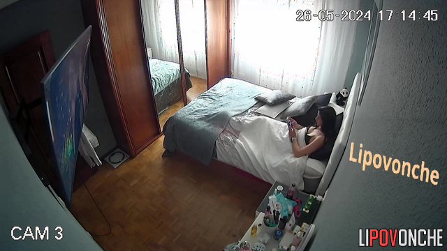 The brunette changed her clothes and began to relax in front of the TV