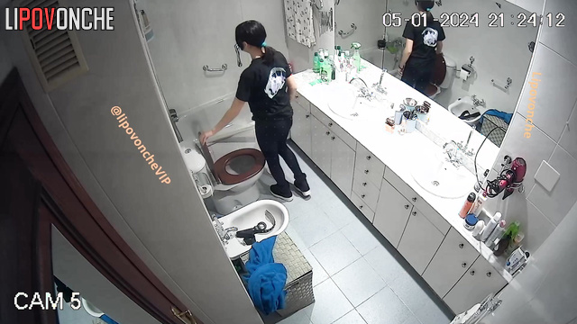 Pretty brunette sitting on the toilet and peeing