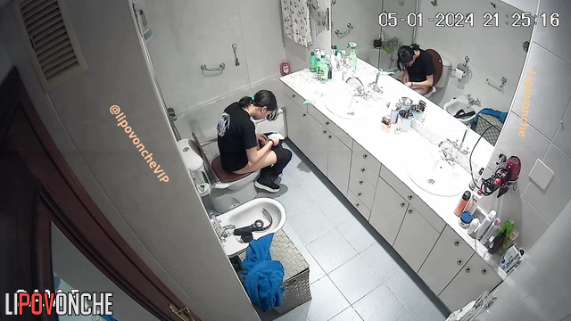 Pretty brunette sitting on the toilet and peeing