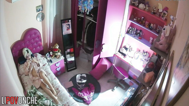 Girl teenager plays in her phone laying in bathrobe and having no lingerie on