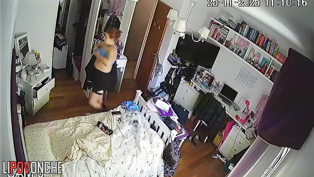 A chubby, red-haired cutie is walking around completely naked in her bedroom