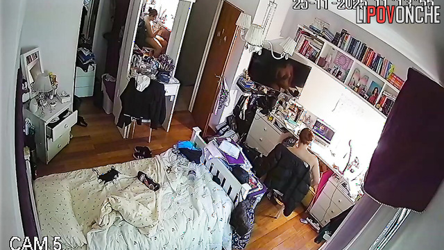 A chubby, red-haired cutie is walking around completely naked in her bedroom