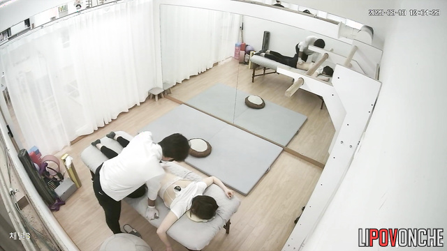 Male physical therapist undresses Asian girl during therapeutic massage