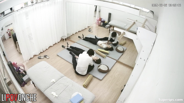 Male physical therapist undresses Asian girl during therapeutic massage
