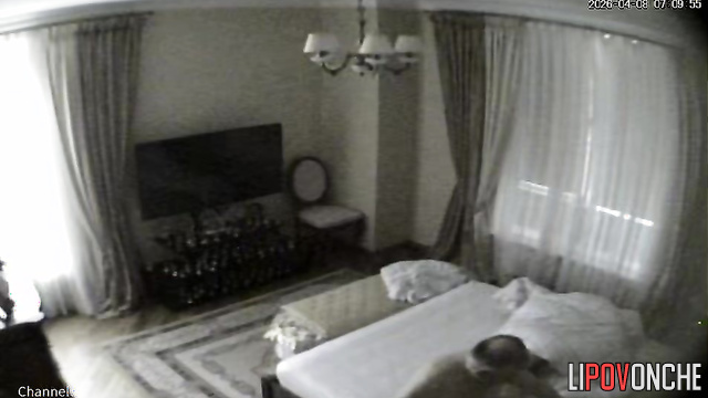 A bald older man gives his naked blonde wife a light massage