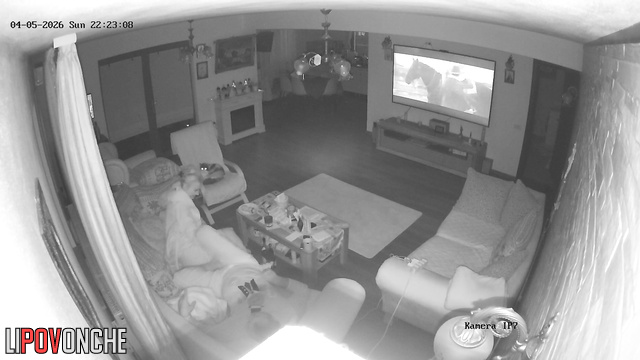 The horny milf impatiently pulls down her husband's underwear while he watches TV