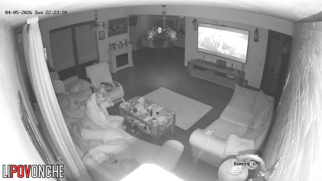 The horny milf impatiently pulls down her husband's underwear while he watches TV