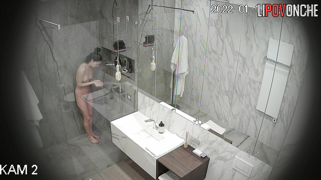 A skinny, naked beauty with a hairy pussy applies her makeup after a shower