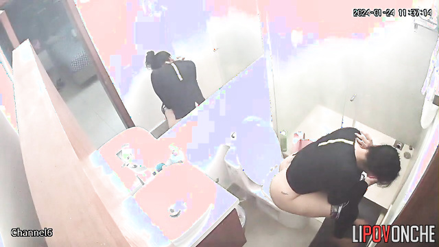 A seductive brunette with a big ass is watching TikTok while sitting on the toilet