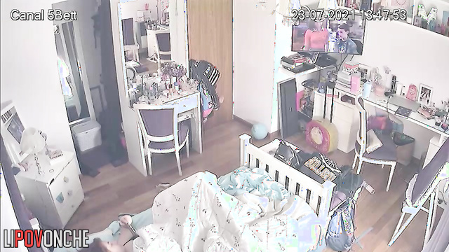 A red-haired teenage girl is caressing her tender pussy under the covers