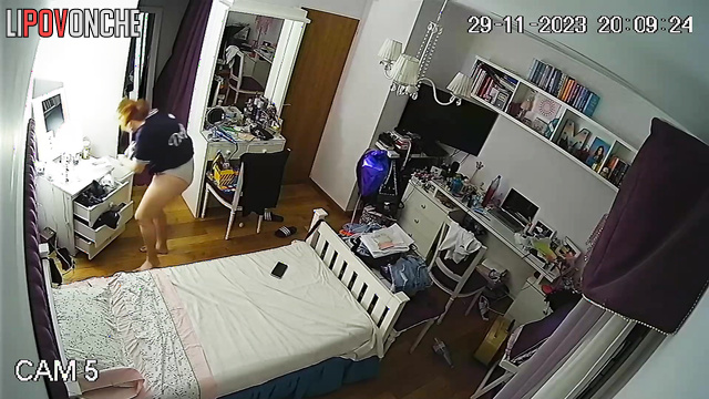 A red-haired cutie put on a striptease photo shoot right in her own bedroom