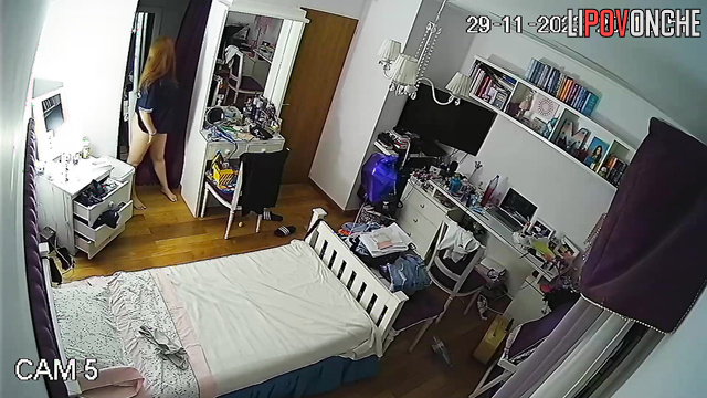 A red-haired cutie put on a striptease photo shoot right in her own bedroom
