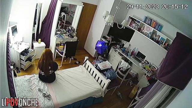 A red-haired cutie put on a striptease photo shoot right in her own bedroom