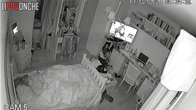 The pretty girl turned up the volume on the TV so no one would hear her moans