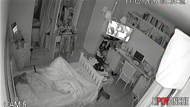 The pretty girl turned up the volume on the TV so no one would hear her moans
