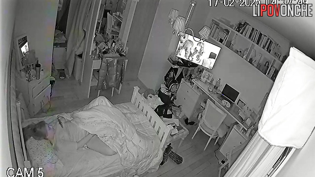 The pretty girl turned up the volume on the TV so no one would hear her moans