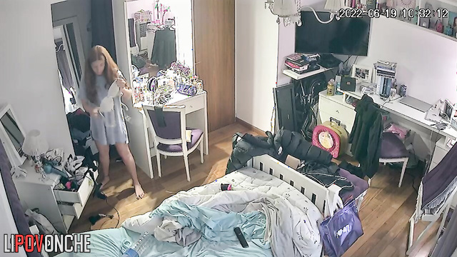 The long-haired beauty slips a new bra onto her perky breasts