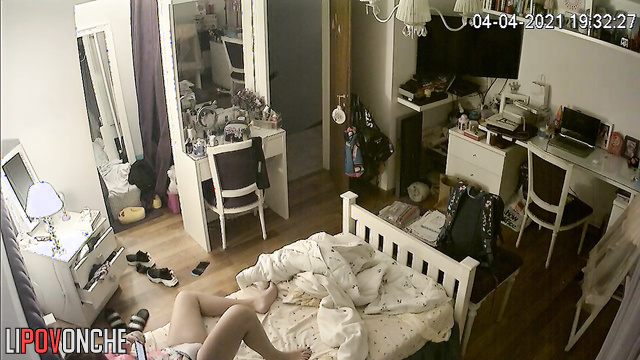A young redheaded cutie is actively playing with her wet pussy under her panties