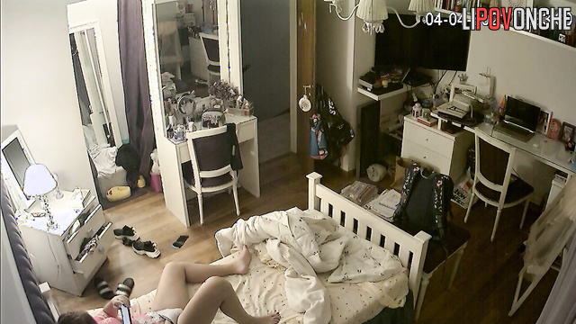 A young redheaded cutie is actively playing with her wet pussy under her panties