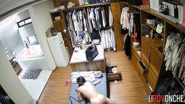 A sexy brunette is rubbing her wet pussy against the dressing room daybed