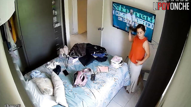 A seductive cutie caresses her naked, sexy body while watching TV