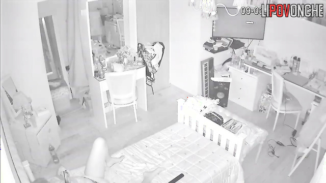 A young cutie slips her fingers into her wet vagina while relaxing in bed