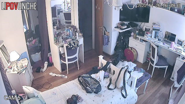 A pretty young lady bares her alluring, firm breasts in front of a hidden camera