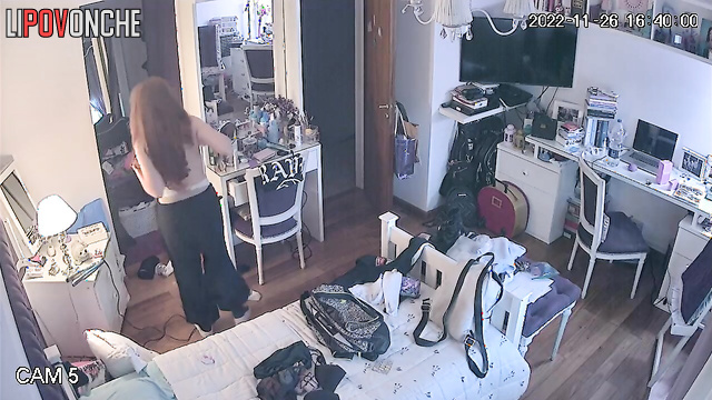 A pretty young lady bares her alluring, firm breasts in front of a hidden camera