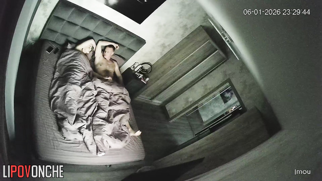 A sassy blonde gently jerks off her husband, who's lying bored in bed