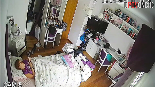 The girl wakes up and seductively takes off her T-shirt, baring her tits