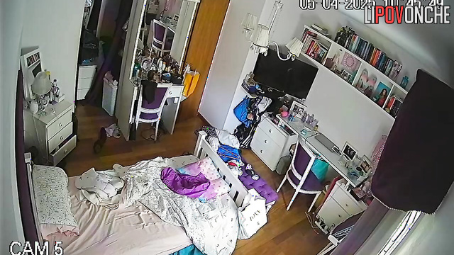 The girl wakes up and seductively takes off her T-shirt, baring her tits