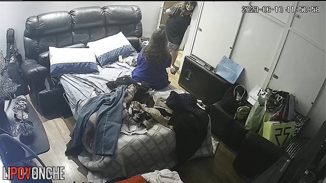 A naked mom gets dressed, ignoring her friends chatting in her bedroom