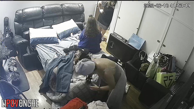 A naked mom gets dressed, ignoring her friends chatting in her bedroom
