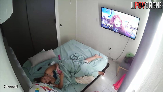 A bored woman inserts a large vibrator to entertain herself in bed