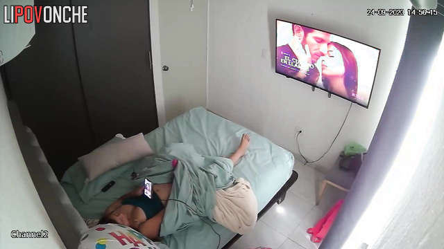 A bored woman inserts a large vibrator to entertain herself in bed