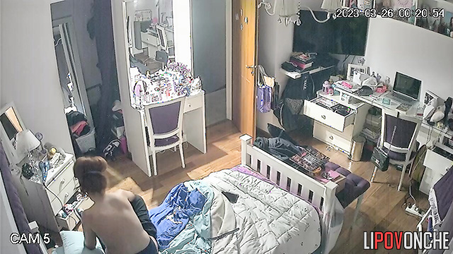The redheaded girl undresses and gazes with interest at her firm tits in the mirror