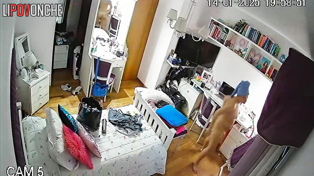 A red-haired student enters her bedroom completely naked after taking a shower