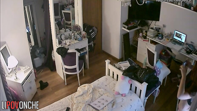 A red-haired teenage girl is taking a selfie in the mirror with her shorts pulled down