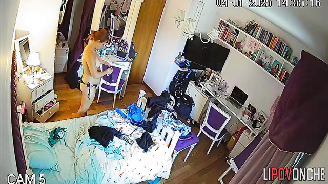 The long-haired redhead strips completely naked while trying on new swimsuits