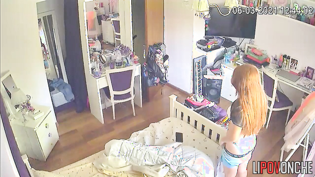 The redhead lifts her T-shirt and pulls down her shorts to admire her underwear