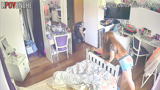 The redhead lifts her T-shirt and pulls down her shorts to admire her underwear