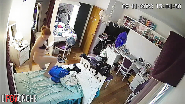 A pretty girl pulls down her panties and examines her shaved pussy in a makeup mirror