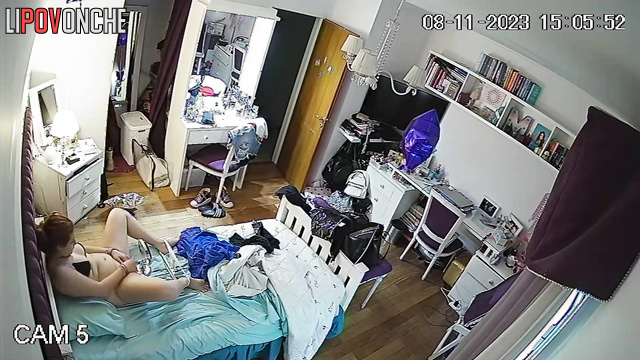 A pretty girl pulls down her panties and examines her shaved pussy in a makeup mirror