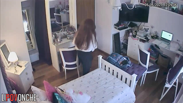 A pretty girl is masturbating on the bed, periodically distracted by messaging