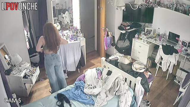 A long-haired cutie bares her perky breasts as she changes her bra