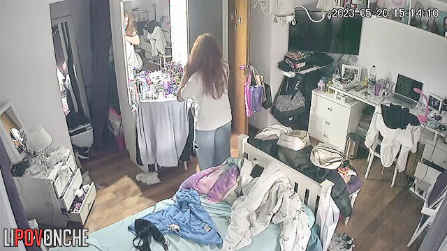 A long-haired cutie bares her perky breasts as she changes her bra