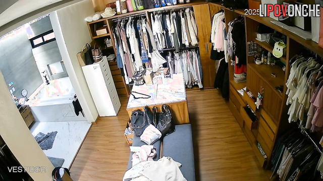 Hidden camera footage from a locker room showing a brunette undressing
